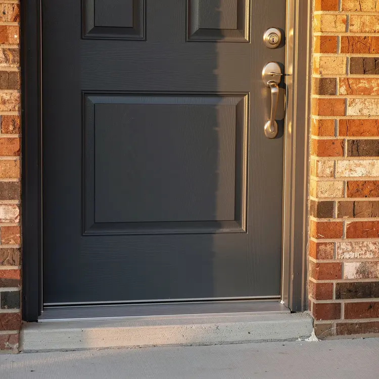 Charcoal Gray Exterior Door with Brick Entryway