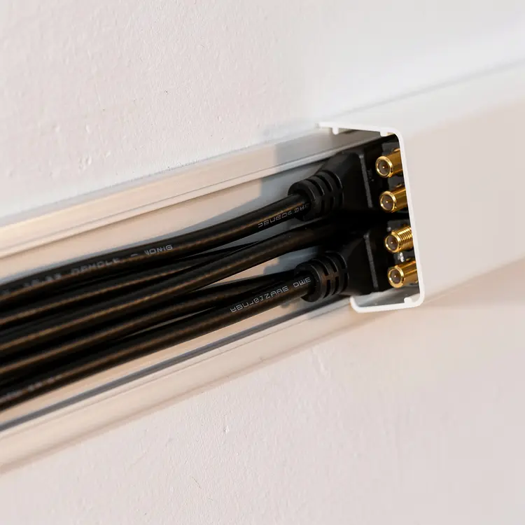 Wall-Mounted Cable Management Channel with Coaxial Cables