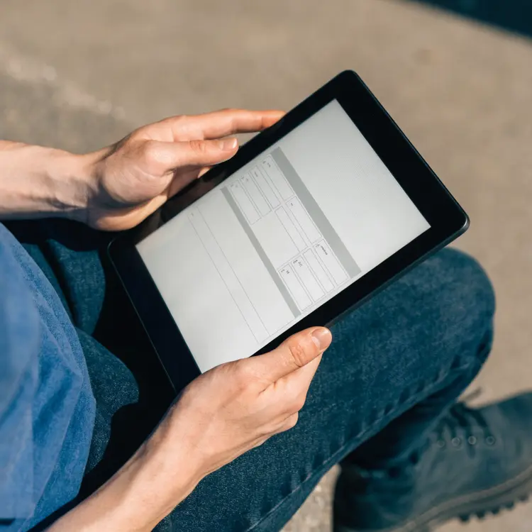 Person Reviewing Document on Tablet