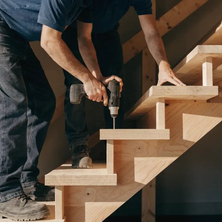 Workers Installing Wooden Staircase