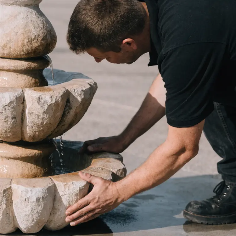 Man Installing Stone Water Fountain