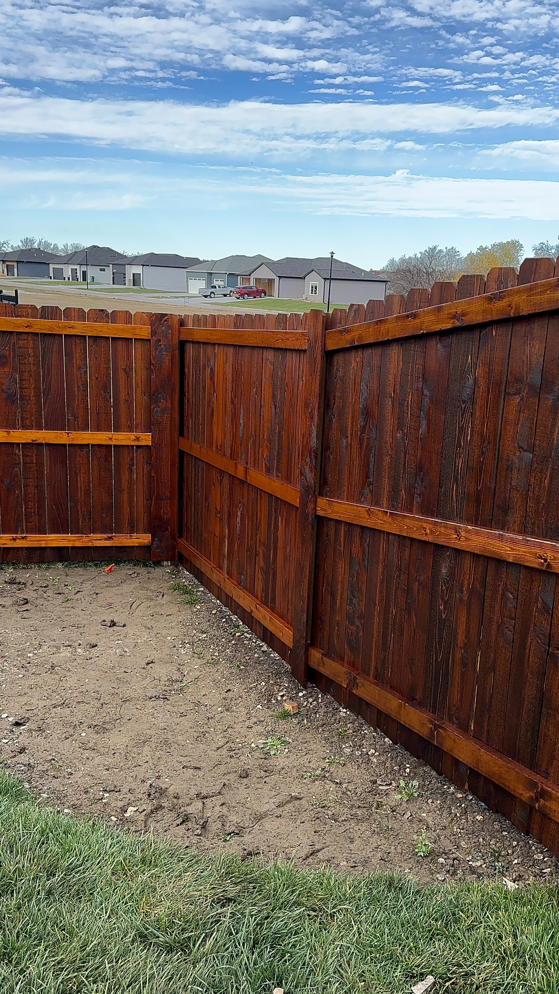 Dark-Stained Cedar Wood Privacy Fence Installation