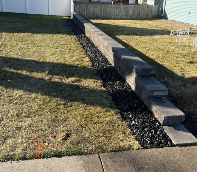 Segmental Block Retaining Wall with Black Rock Landscaping