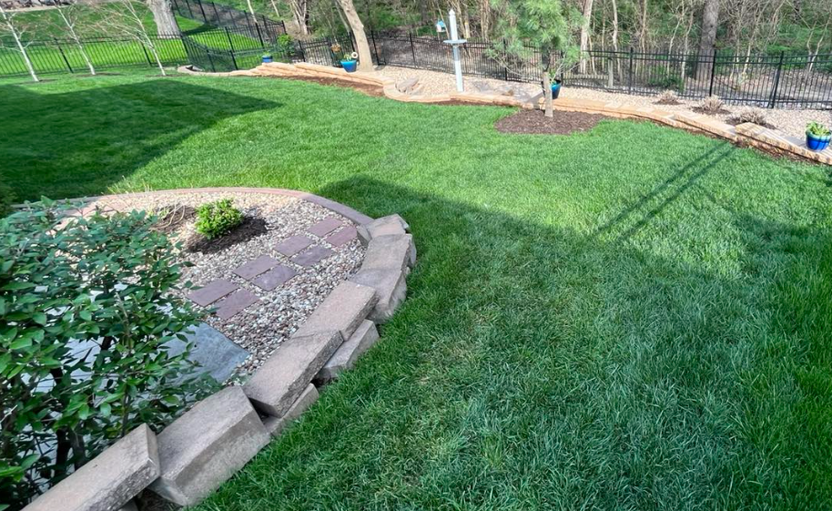 Custom Backyard Landscape with Stone Retaining Walls & Lush Lawn