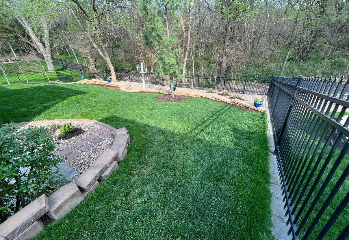 Backyard Landscape Design with Retaining Walls & Manicured Lawn
