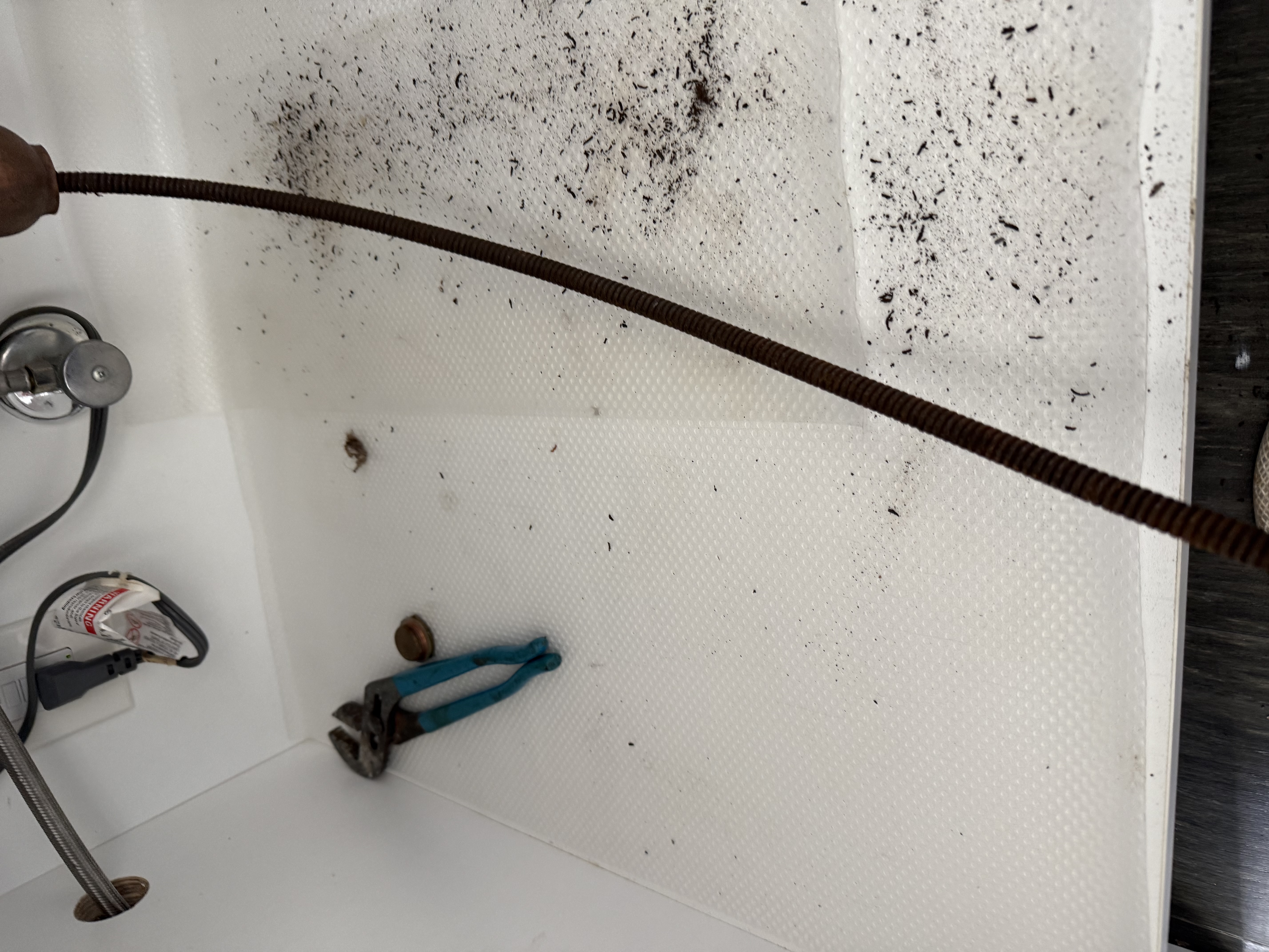 Drain Snake Cleaning – Debris Removal in Progress