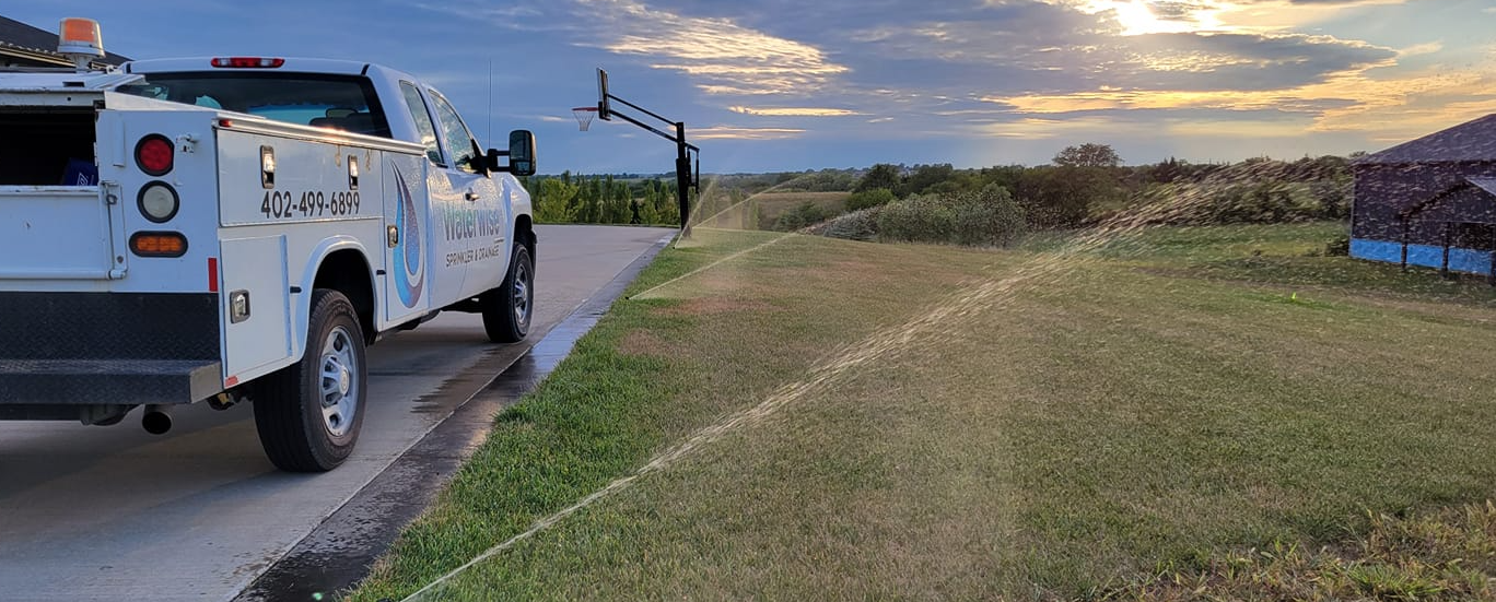 Residential Sprinkler System in Action at Sunset