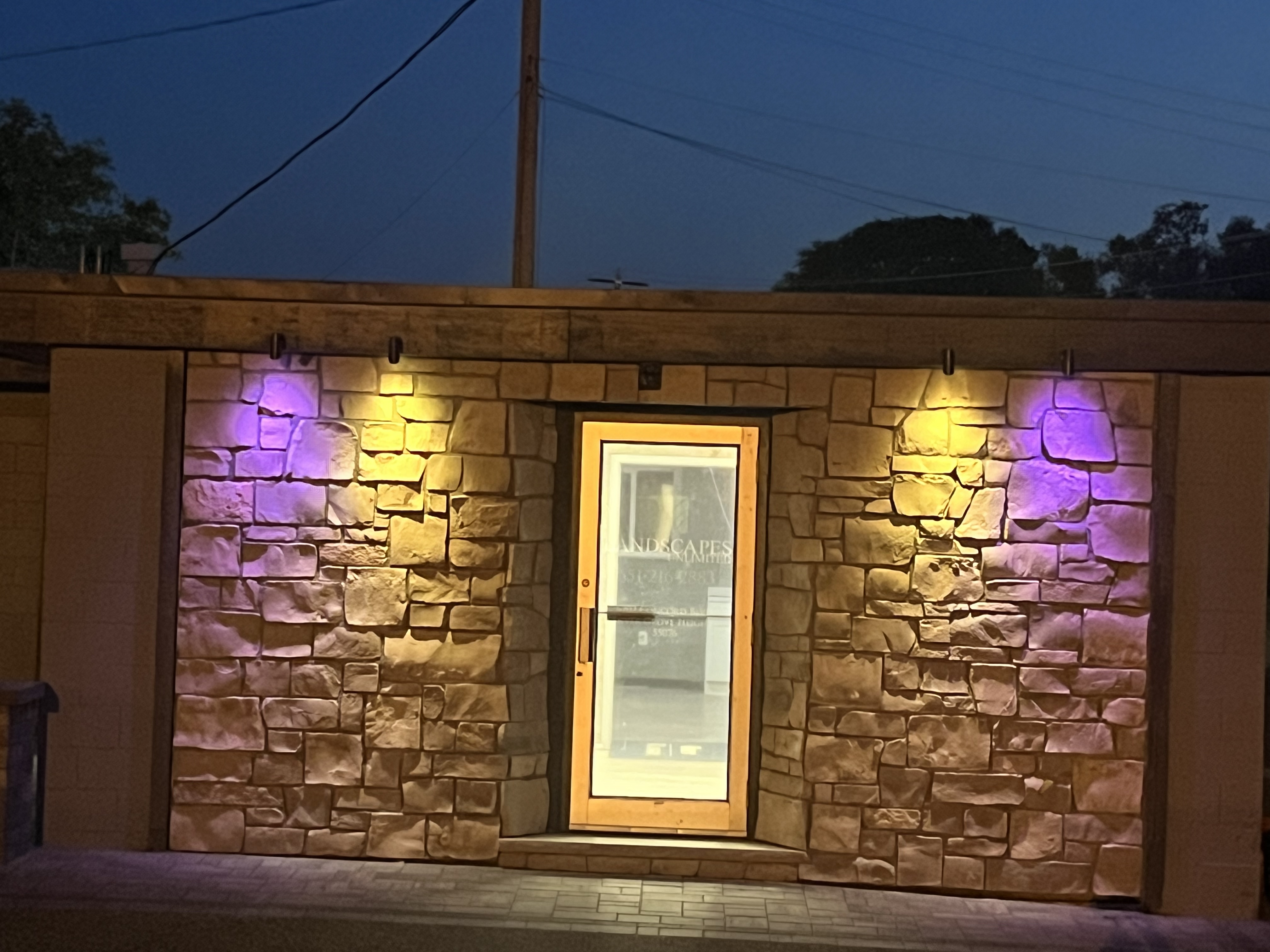 Commercial Stone Building Exterior with Accent Lighting at Night