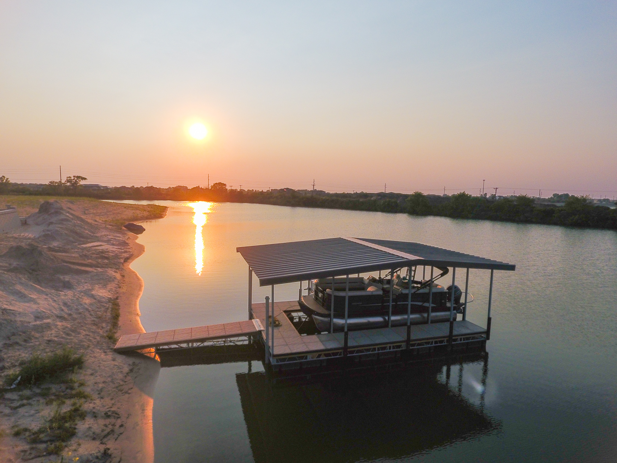 Covered Pontoon Boat Lift & Dock Installation at Sunset