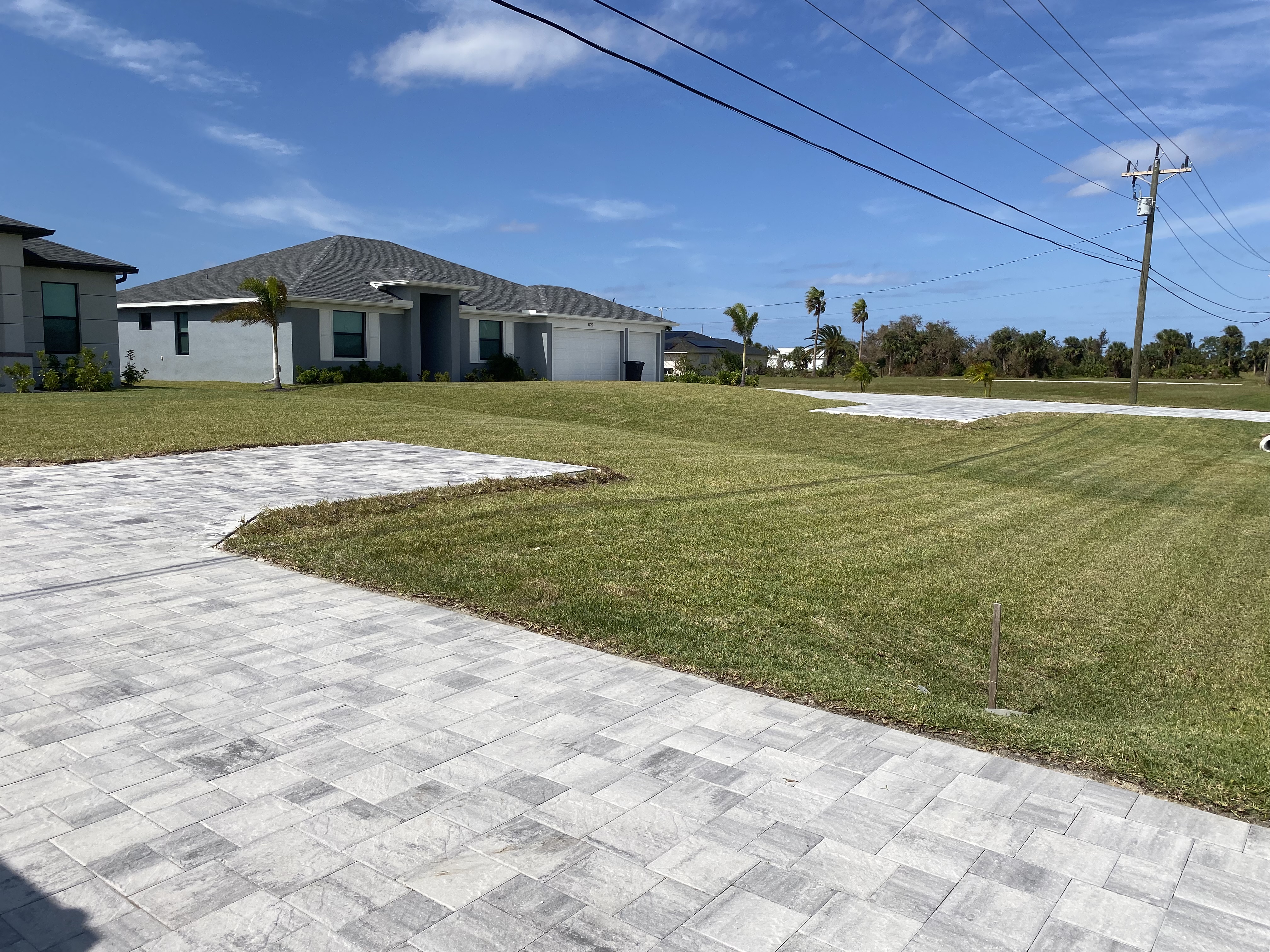 Freshly Mowed Residential Lawn with Paver Driveway – Cape Coral, FL
