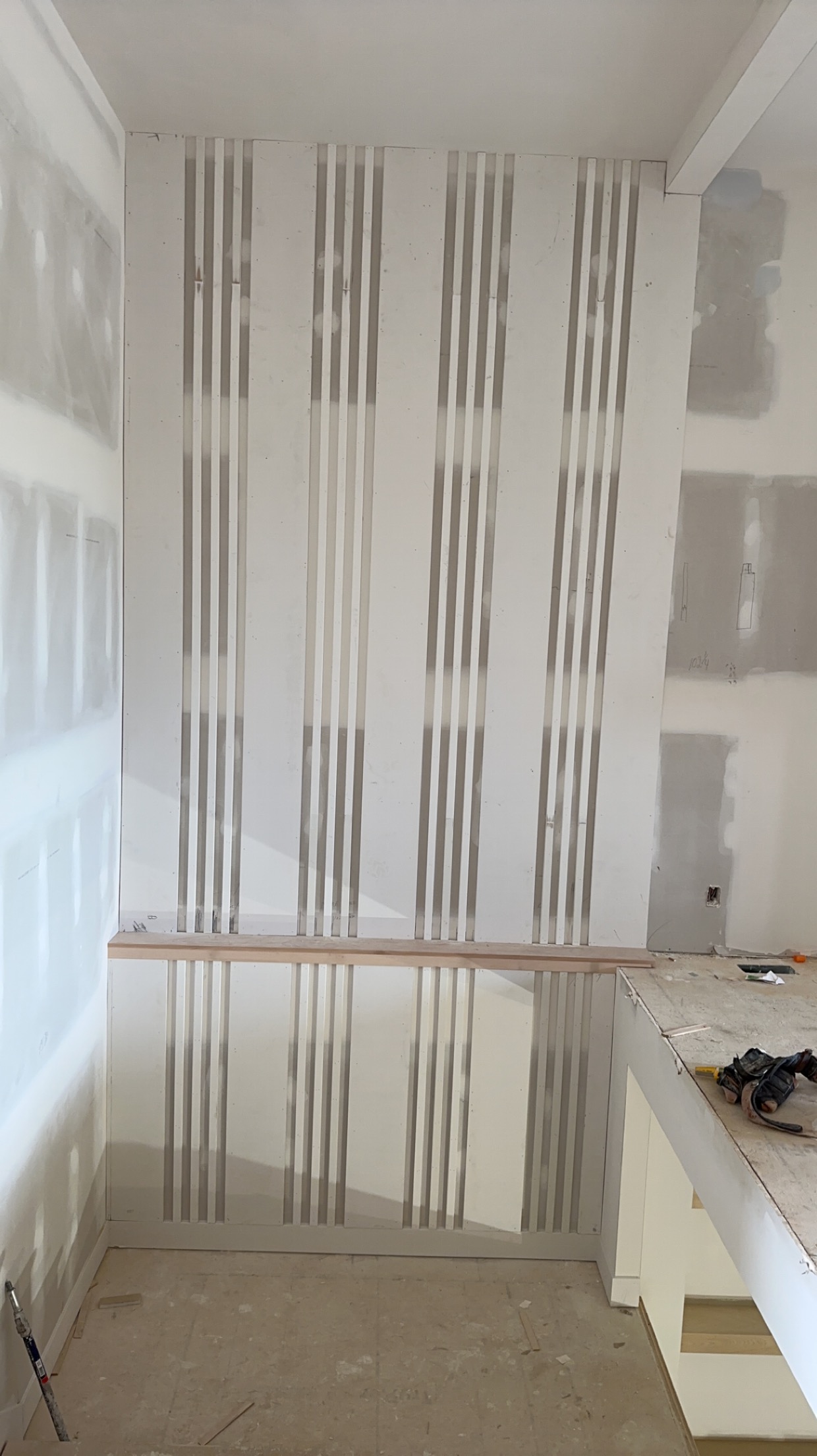 Vertical Slat Accent Wall – Trim Installation in Progress