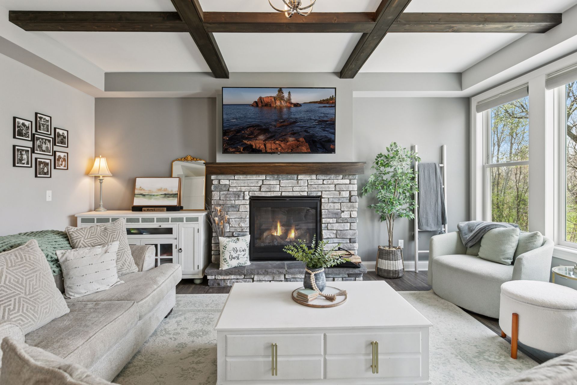 Spotless Living Room with Stone Fireplace & Coffered Ceiling