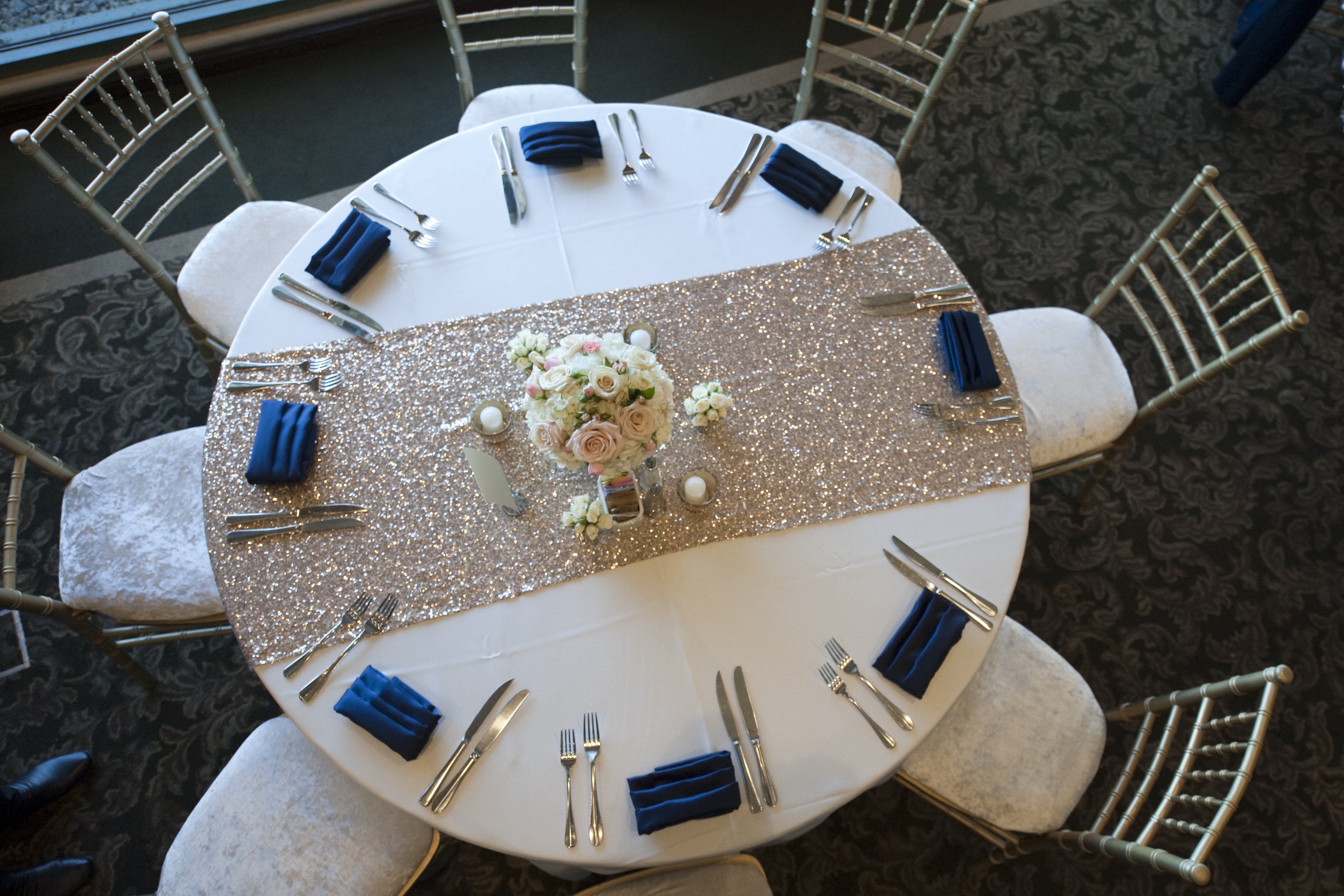 Elegant Wedding Reception Table Setting with Gold Sequin Runner