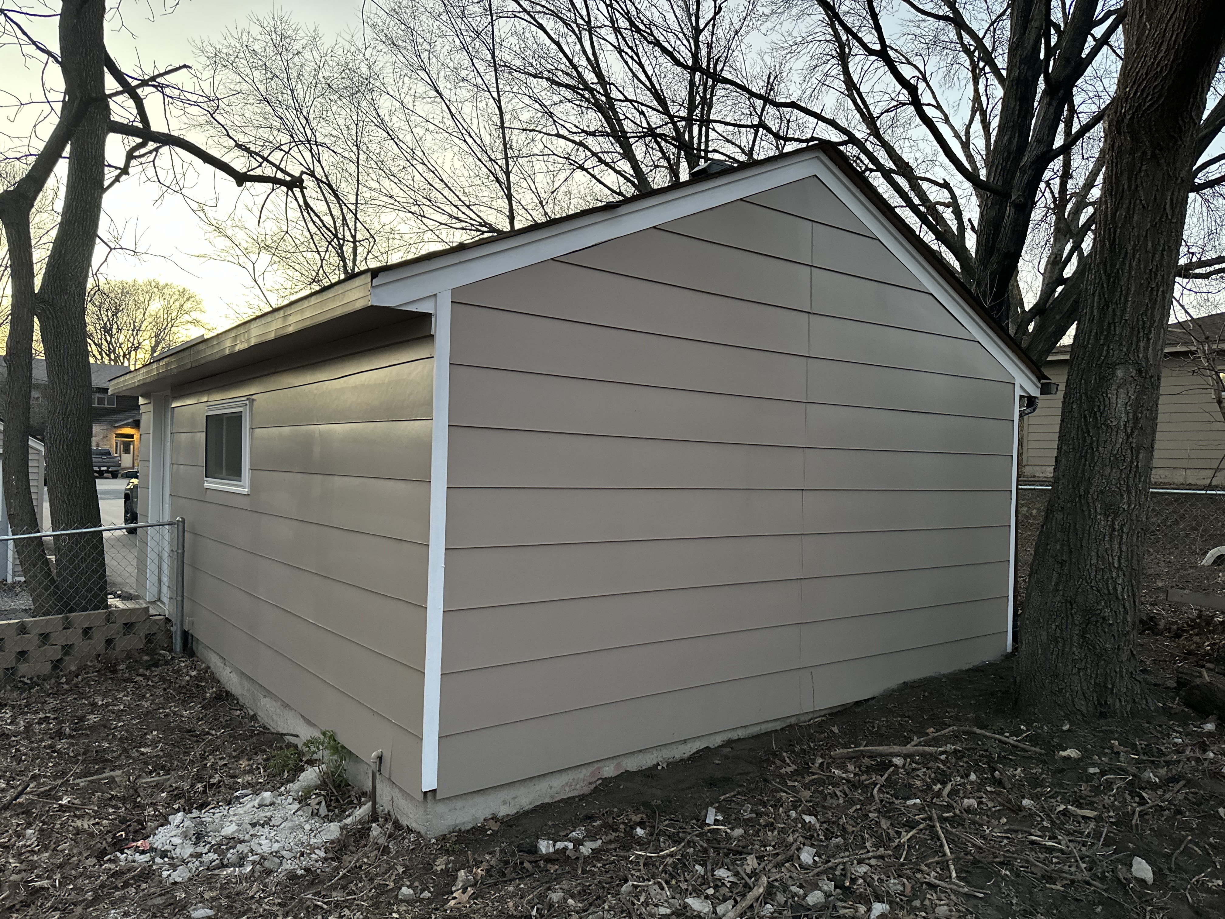 Exterior Shed & Garage Painting – Tan Siding with White Trim